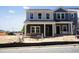 Two-story new construction home featuring mixed-material facade and covered front porch at 3714 Rosebush Dr, Zebulon, NC 27597