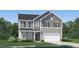 Charming two-story home featuring a two-car garage, gray siding and a well-manicured lawn at 4024 Shadbush St, Raleigh, NC 27616