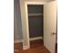 Open bedroom closet with gray interior, single wood shelf, and hardwood floors at 405 Starrett Ct, Raleigh, NC 27603