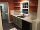 Modern kitchen with stainless steel sink, dishwasher, sleek countertops and floating shelves at 405 Starrett Ct, Raleigh, NC 27603