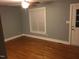 Bright living room featuring hardwood floors, a ceiling fan, and natural light from a window at 405 Starrett Ct, Raleigh, NC 27603