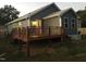Rear of the home showcasing a large wooden deck, blue siding, and well-maintained landscaping at 405 Starrett Ct, Raleigh, NC 27603
