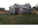 Exterior rear view featuring a spacious yard, wooden deck, and blue siding at 405 Starrett Ct, Raleigh, NC 27603
