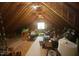 Unfinished attic space with exposed beams, a window, and abundant storage potential at 423 Oakland Dr, Raleigh, NC 27609