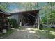 Barn with partially open walls, exposing the frame and equipment inside, surrounded by trees at 423 Oakland Dr, Raleigh, NC 27609