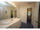 Bathroom featuring a large vanity with sink and access to an adjoining toilet and sink at 423 Oakland Dr, Raleigh, NC 27609