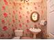 Charming powder room with decorative floral wallpaper and a stylish pedestal sink at 423 Oakland Dr, Raleigh, NC 27609
