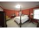Cozy bedroom with neutral walls, four-poster bed, and ample natural light at 423 Oakland Dr, Raleigh, NC 27609