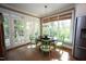 Bright dining area with hardwood floors, French doors, and a view of the lush, green outdoors at 423 Oakland Dr, Raleigh, NC 27609