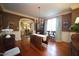 Elegant dining room with a chandelier, hardwood floors, and an archway leading to the living room at 423 Oakland Dr, Raleigh, NC 27609