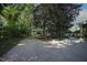 Long driveway leading to home, garage, and backyard, all set amidst mature trees at 423 Oakland Dr, Raleigh, NC 27609