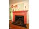 Living area with a decorative fireplace with a detailed fire screen and a colorful painting above at 423 Oakland Dr, Raleigh, NC 27609