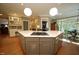 Gourmet kitchen with a large island, gas cooktop, breakfast bar, and seamless flow into the dining area and living spaces at 423 Oakland Dr, Raleigh, NC 27609