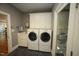 Well-appointed laundry room features a modern washer and dryer with upper cabinets at 423 Oakland Dr, Raleigh, NC 27609
