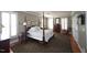 Comfortable main bedroom features a four-poster bed, hardwood floors, and plenty of natural light at 423 Oakland Dr, Raleigh, NC 27609