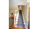 Traditional staircase featuring hardwood floors, carpet runner, and access to multiple levels at 423 Oakland Dr, Raleigh, NC 27609