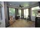 Inviting sunroom with lots of windows, comfortable seating, wood floors and ceiling fan at 423 Oakland Dr, Raleigh, NC 27609