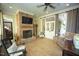 Cozy sunroom featuring a brick fireplace, ceiling fan, and sliding glass doors at 423 Oakland Dr, Raleigh, NC 27609