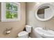 Bathroom showcasing modern toilet and vanity near a window for natural light at 4420 Tetbury Pl, Raleigh, NC 27613