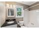 Traditional bathroom with a granite vanity, modern fixtures, and a window for natural light at 4420 Tetbury Pl, Raleigh, NC 27613