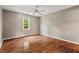 A well-lit bedroom with a ceiling fan and gleaming laminate flooring at 4420 Tetbury Pl, Raleigh, NC 27613