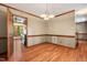 Dining room featuring a chandelier with wood floors and trim at 4420 Tetbury Pl, Raleigh, NC 27613