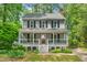 Charming two-story home with a welcoming front porch and mature landscaping at 4420 Tetbury Pl, Raleigh, NC 27613