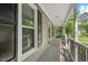 Relaxing covered front porch features neutral siding and black railings at 4420 Tetbury Pl, Raleigh, NC 27613