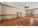 Spacious living room featuring wood floors, a ceiling fan, and a brick fireplace at 4420 Tetbury Pl, Raleigh, NC 27613