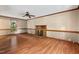 Warm living room with fireplace, wood floors, and ceiling fan at 4420 Tetbury Pl, Raleigh, NC 27613