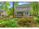 Charming two-story home with a covered back porch, surrounded by lush landscaping and mature trees at 4420 Tetbury Pl, Raleigh, NC 27613