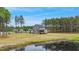 Aerial view showcasing home, large lot, pond, and surrounding greenery at 4455 Old Us 421, Lillington, NC 27546