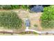 Overhead shot of a home with an inviting driveway, colorful landscaping, and surrounded by lush trees and a private pond at 4455 Old Us 421, Lillington, NC 27546