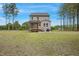 Spacious backyard with a two-story home, screened-in porch, and lush greenery at 4455 Old Us 421, Lillington, NC 27546
