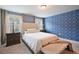 Comfortable bedroom featuring an accent wall and soft, natural lighting at 4455 Old Us 421, Lillington, NC 27546