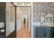 Inviting entryway with modern wallpaper, wainscoting, a wood floor and access to the living spaces at 4455 Old Us 421, Lillington, NC 27546