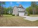 Side view of a charming two-story home with a spacious manicured lawn and a two-car garage at 4455 Old Us 421, Lillington, NC 27546
