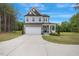 Charming two-story home with a two-car garage and covered porch set on a spacious manicured lawn at 4455 Old Us 421, Lillington, NC 27546