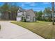 Back view of a charming two-story home with a spacious manicured lawn and attached two-car garage at 4455 Old Us 421, Lillington, NC 27546