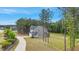 View of a charming two-story home with gray siding, a welcoming front porch, and a beautifully landscaped yard at 4455 Old Us 421, Lillington, NC 27546