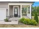 Close up of home's front door and porch framed with stately columns and manicured landscaping at 4455 Old Us 421, Lillington, NC 27546