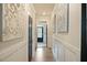 Bright hallway with wainscoting and decorative artwork leading to the main living areas at 4455 Old Us 421, Lillington, NC 27546