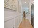 Hallway with modern artwork and wainscoting that offers seamless access to the living room and staircase at 4455 Old Us 421, Lillington, NC 27546