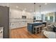 Well-lit kitchen with stainless steel appliances, island with seating, and white cabinetry at 4455 Old Us 421, Lillington, NC 27546