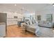 Open-concept living area with modern kitchen, island, stainless appliances, and hardwood floors at 4455 Old Us 421, Lillington, NC 27546