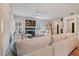 Open-concept living room featuring a fireplace and large windows for natural light and backyard views at 4455 Old Us 421, Lillington, NC 27546