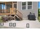 Outdoor patio with seating, grill, and stairs leading to the screened-in porch at 4455 Old Us 421, Lillington, NC 27546
