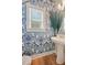 Stylish powder room with unique wallpaper, floating sink, hardwood floors, and bright lighting at 4455 Old Us 421, Lillington, NC 27546