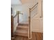 Carpeted staircase with wood and white railing showcasing classic design details at 4455 Old Us 421, Lillington, NC 27546