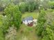 Aerial view of home featuring a large deck and sprawling green lawn with mature trees at 4612 River Farm Rd, Rocky Mount, NC 27803
